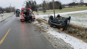 Overturned vehicle accident winter roadside recovery