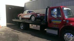 Kreager tow truck carrying a vintage Corvette