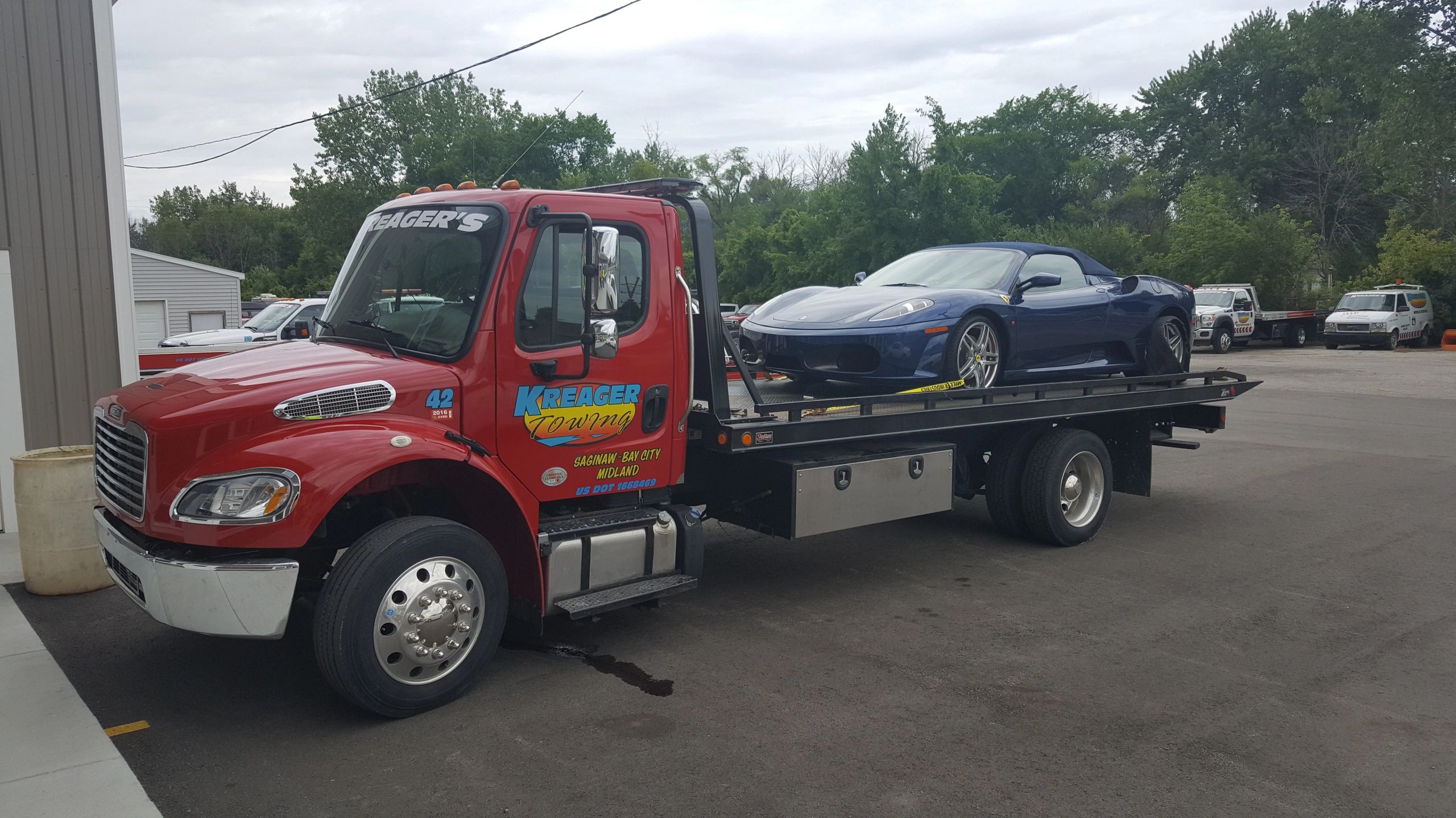 Kreager tow truck transporting sports car
