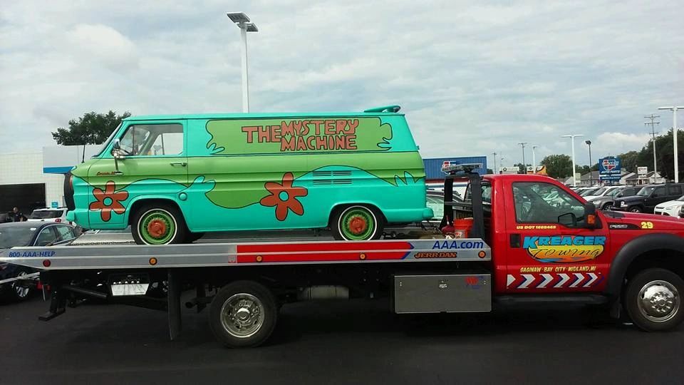 Flatbed tow truck transporting a van